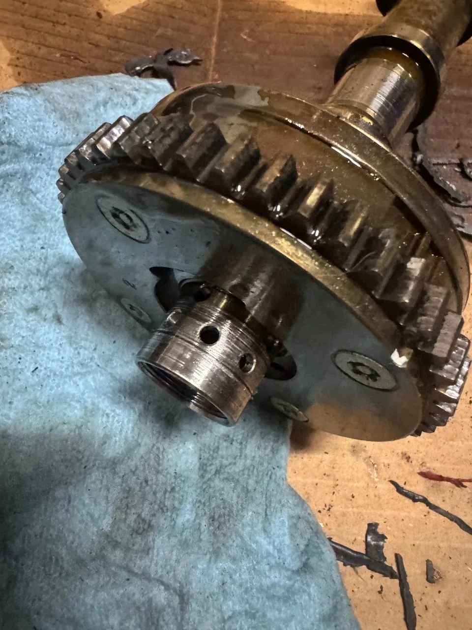 Removed camshaft with a visibly worn camshaft adjuster from a 2014 Volkswagen Passat.