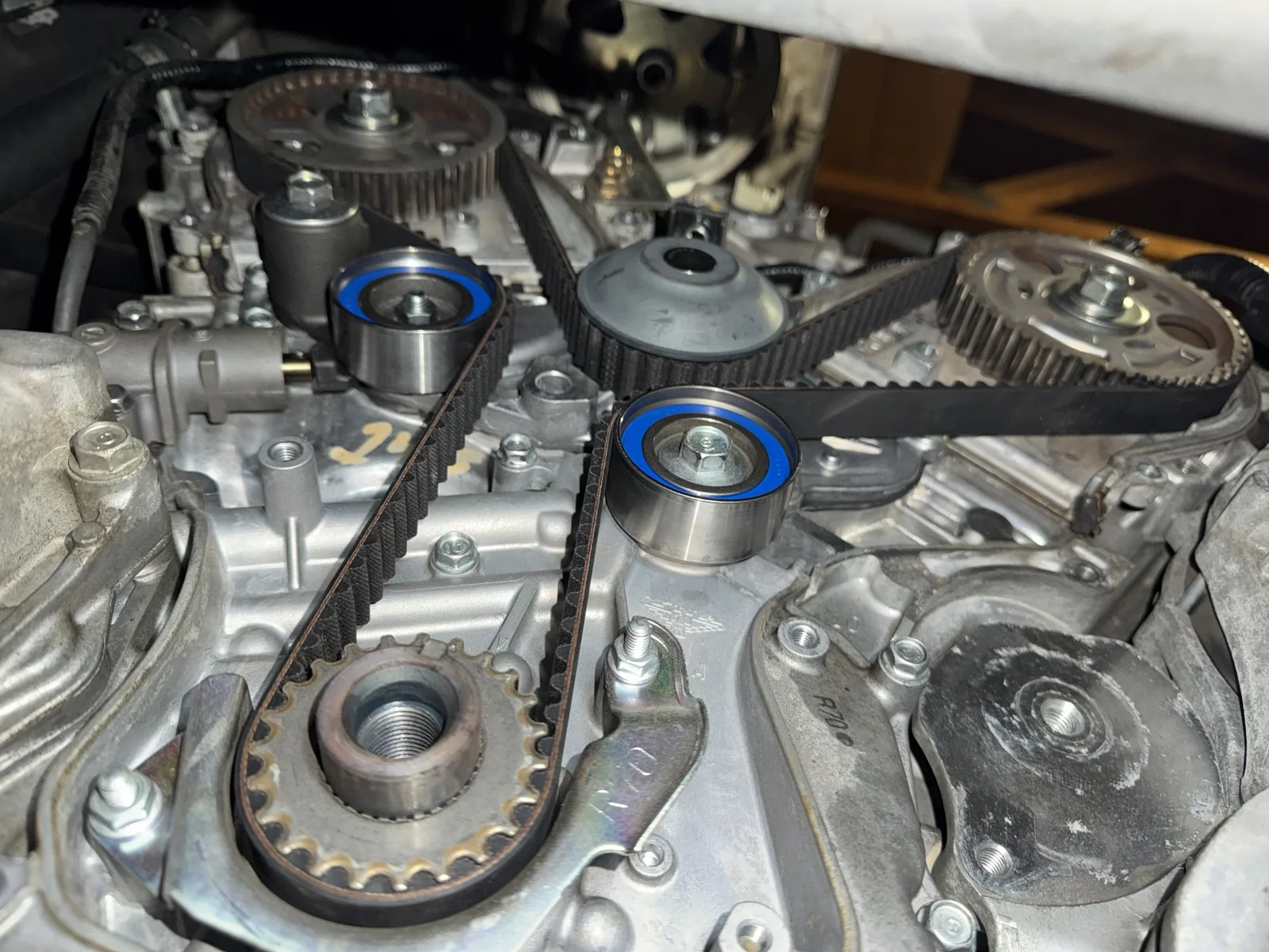 Exposed timing belt, pulleys and camshaft sprockets on a 2015 Honda Odyssey.