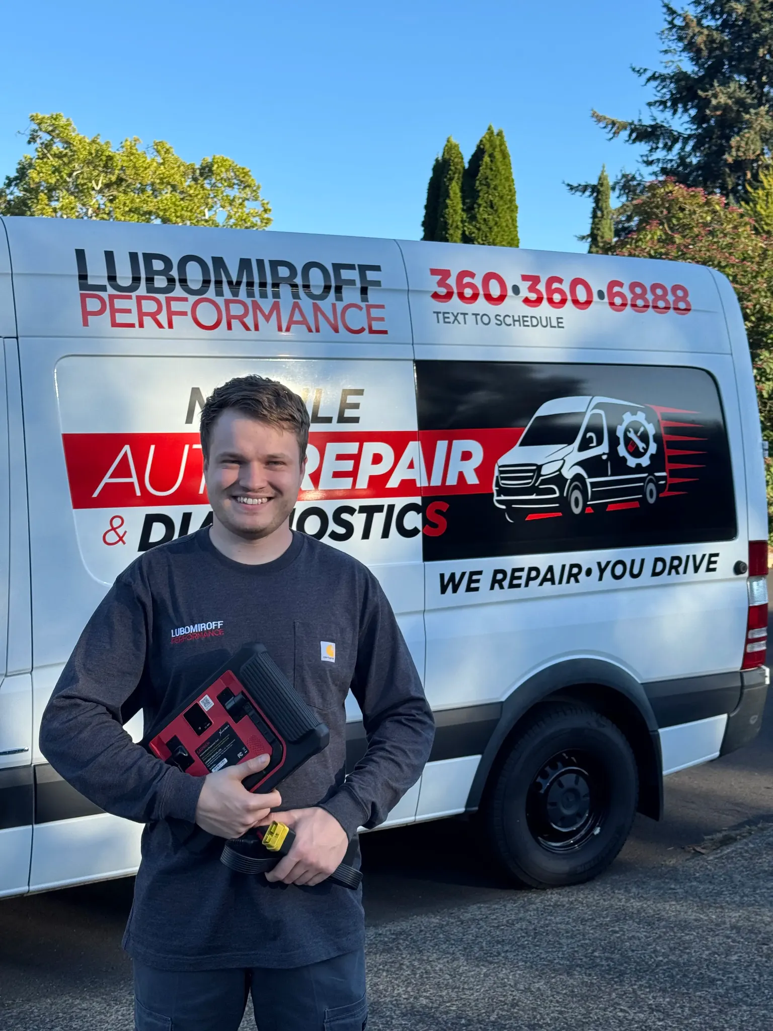 Alex in front of the Lubomiroff Performance mobile service van