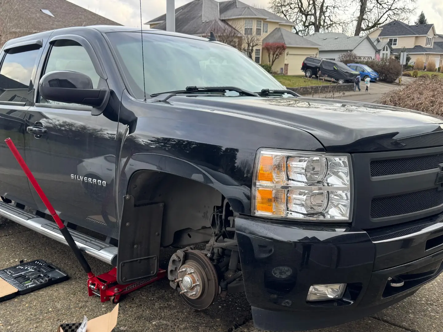 2015 Chevrolet Silverado 1500 with a front wheel removed during brake pad replacement.