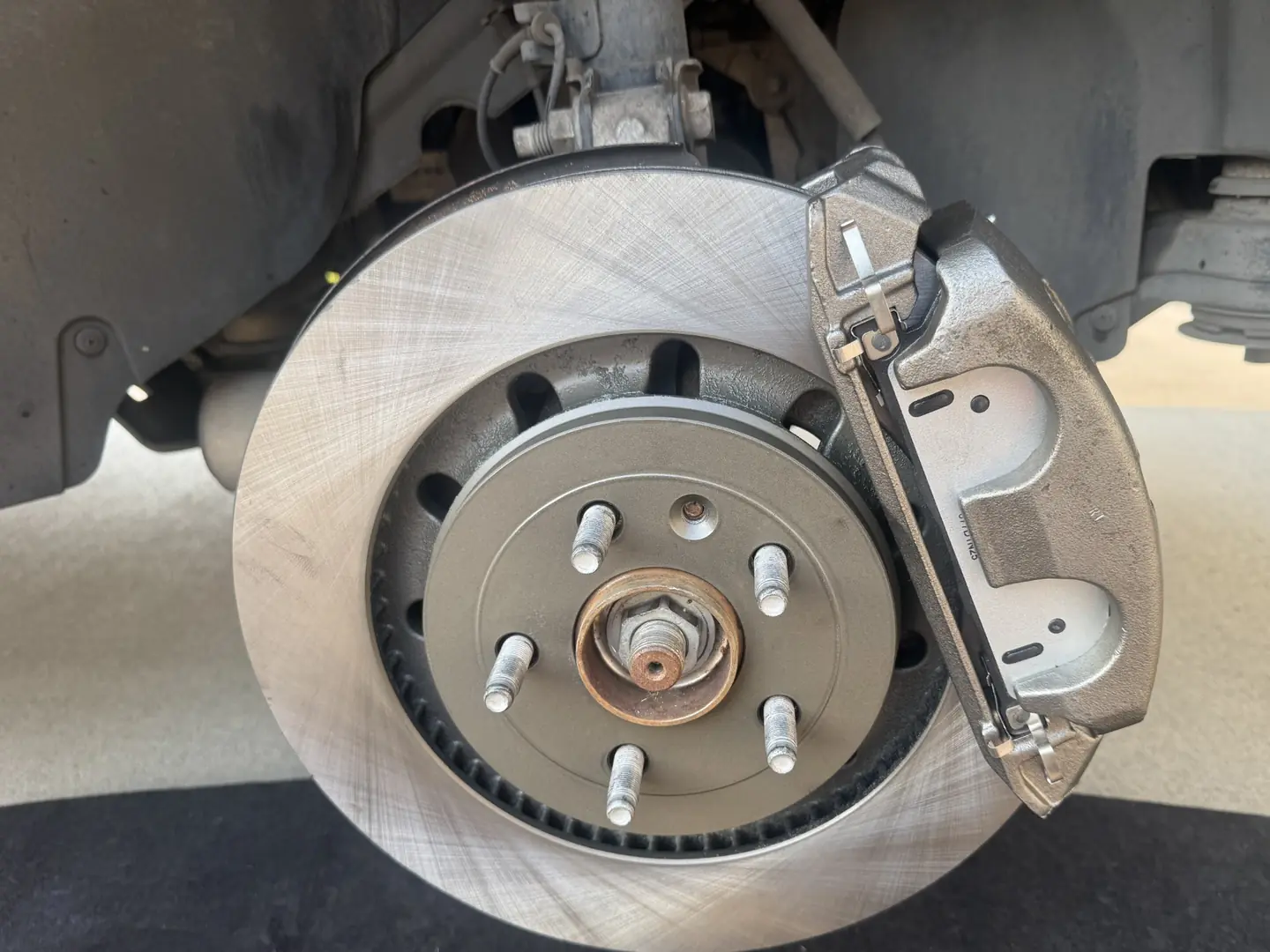 New front brake caliper, rotor and brake pads installed on a 2017 Ford Explorer.