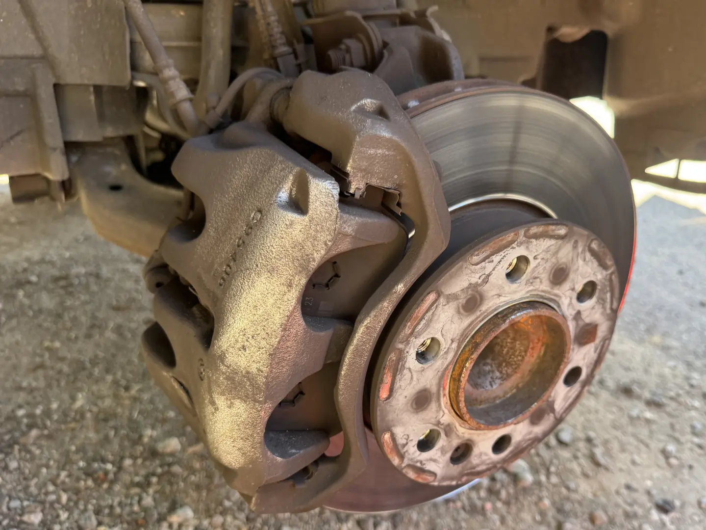 Original front brake rotor and caliper on a 2023 Mercedes-Benz Sprinter before the brake upgrade.