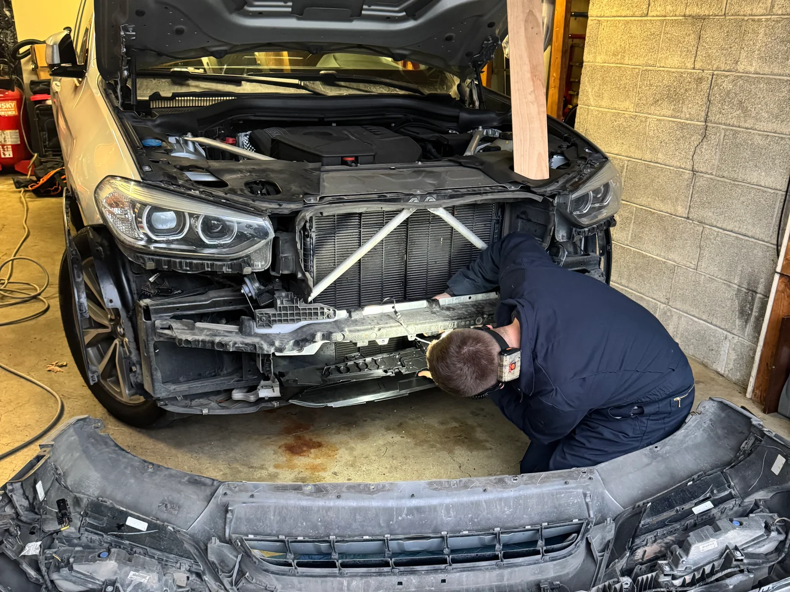 2019 BMW X3 with the front bumper removed during active grille shutter replacement.