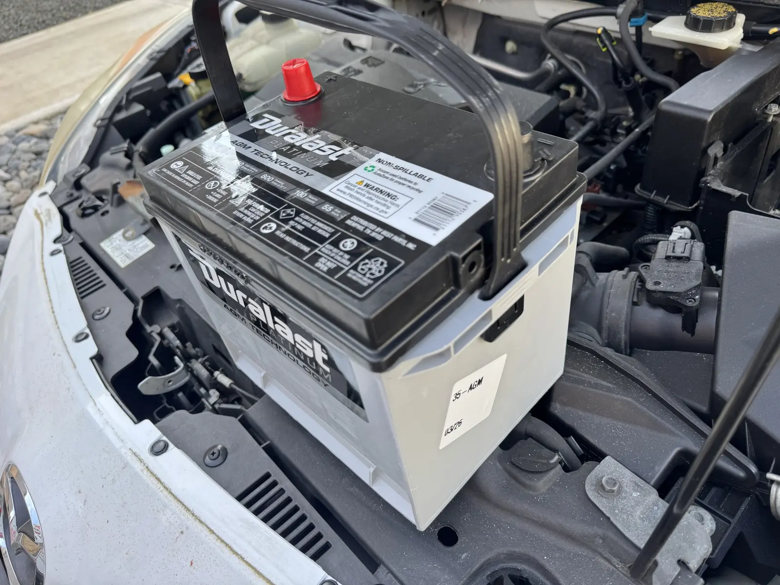 New battery prepared for installation in a 2013 Mazda3.