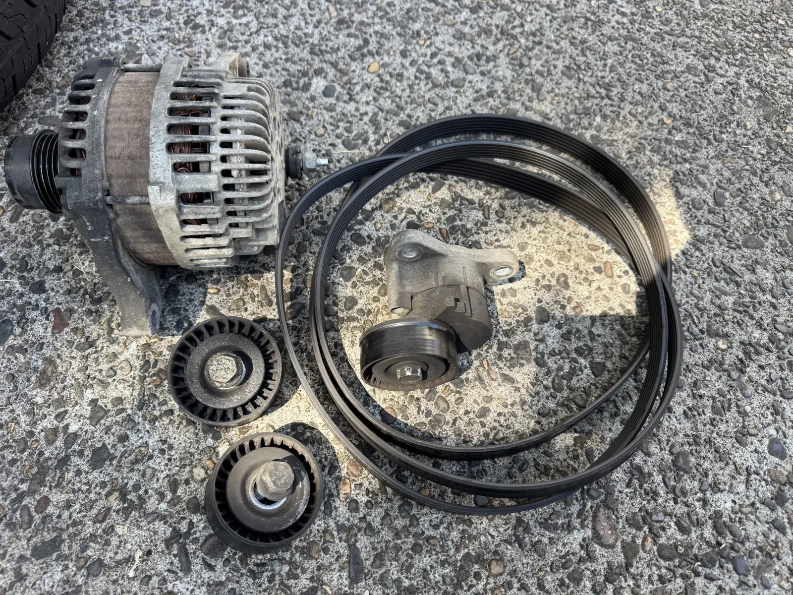 Removed alternator, serpentine belt and drive pulleys from a 2014 Jeep Patriot.