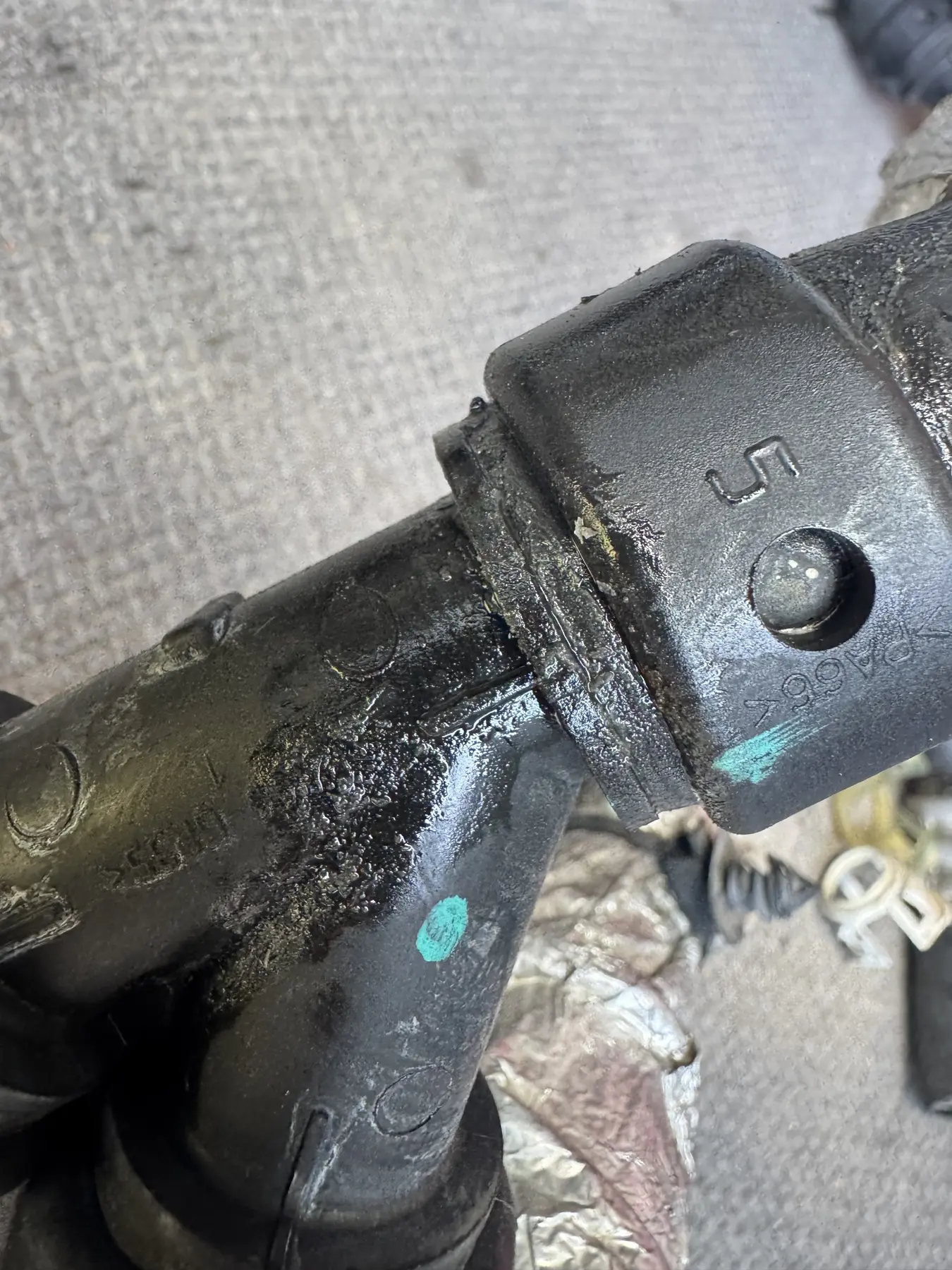 Coolant residue around the leaking plastic hose connector from a Ford Expedition