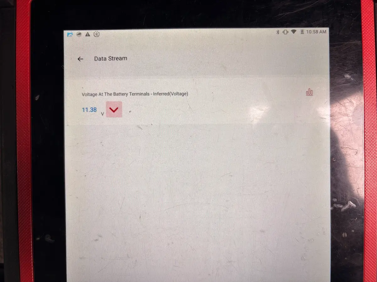 Battery tester showing 11.38 volts during the Lincoln Navigator inspection.
