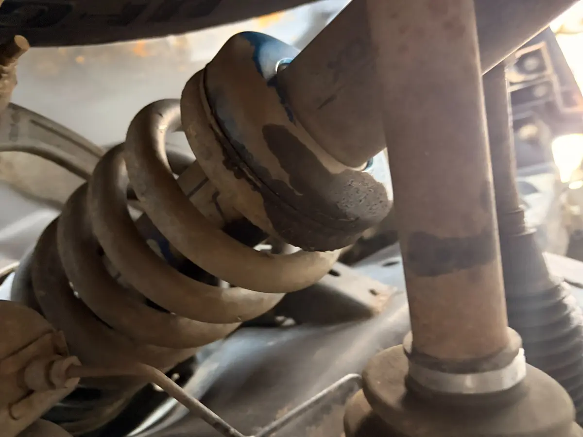 Leaking right-front shock found during the Ford Raptor inspection.