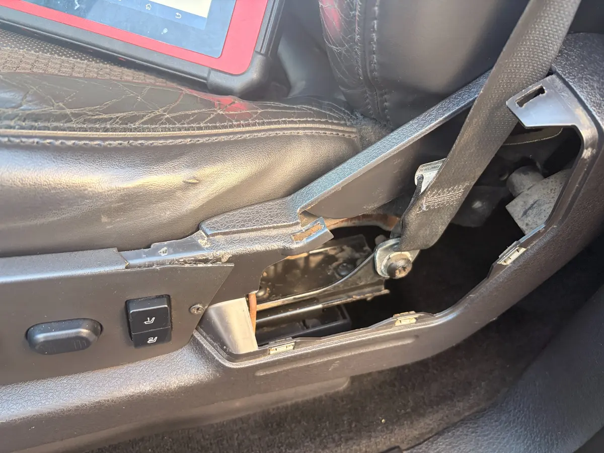 Broken driver-seat trim documented inside the Ford Raptor.