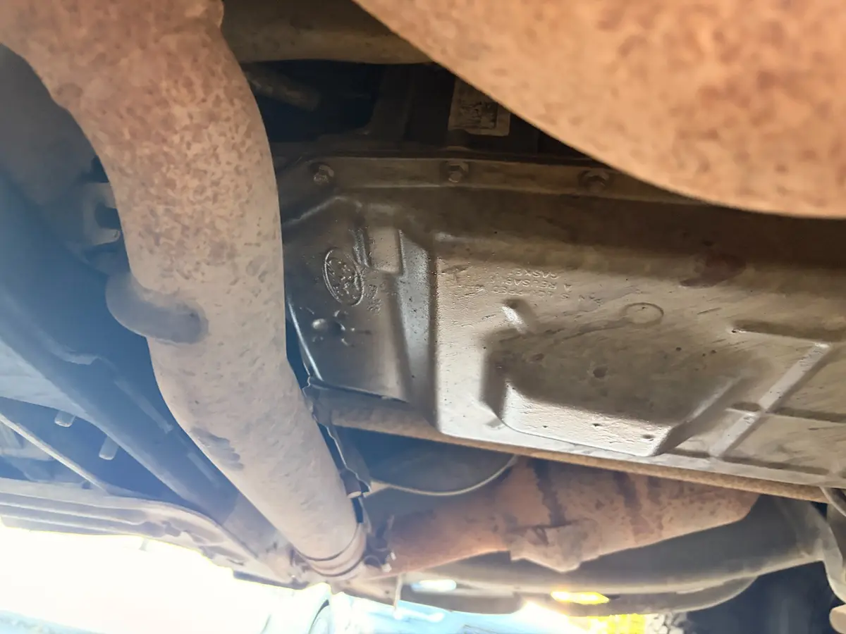 Fresh transmission-fluid leak documented underneath the Ford Raptor.