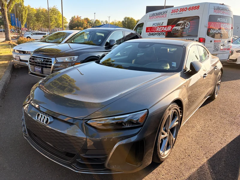 Gray Audi e-tron GT parked in front of the Lubomiroff Performance mobile service van